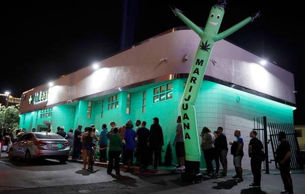 People line up at the NuLeaf marijuana dispensary in Las Vegas on July 1st, 2017. John Locher/AP